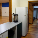 kitchen: eating utensils, fridge, and hot water urn