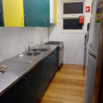 kitchen: cooking utensils, sink, oven, microwave